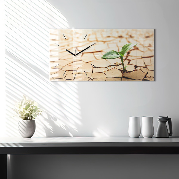 Horloge rectangulaire horizontale Une plante dans un sol asséché