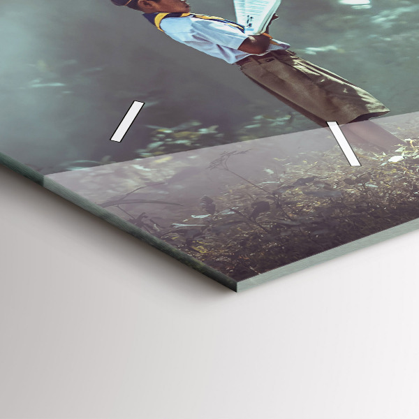 Horloge murale horizontale Un garçon lit un livre