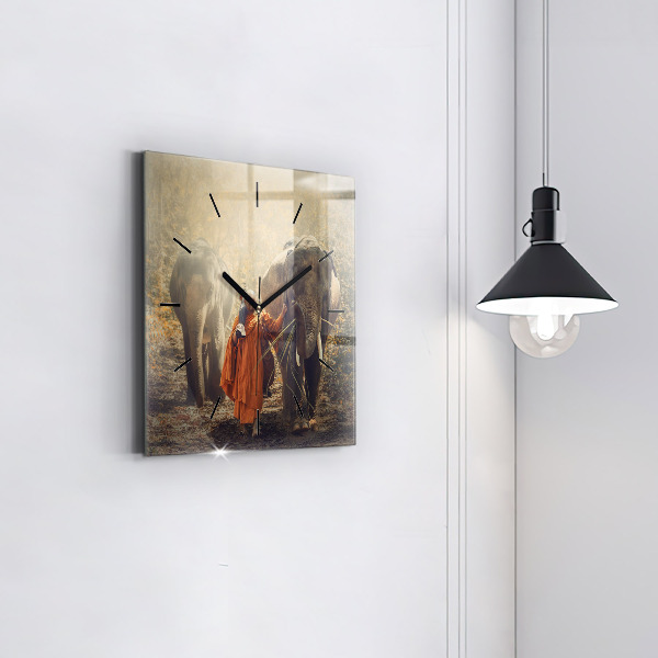 Horloge murale carrée Moine conduisant des éléphants