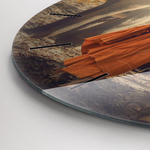 Horloge ronde Moine conduisant des éléphants